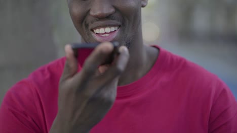 Closeup-of-young-male-mouth-talking-on-phone-with-speakerphone